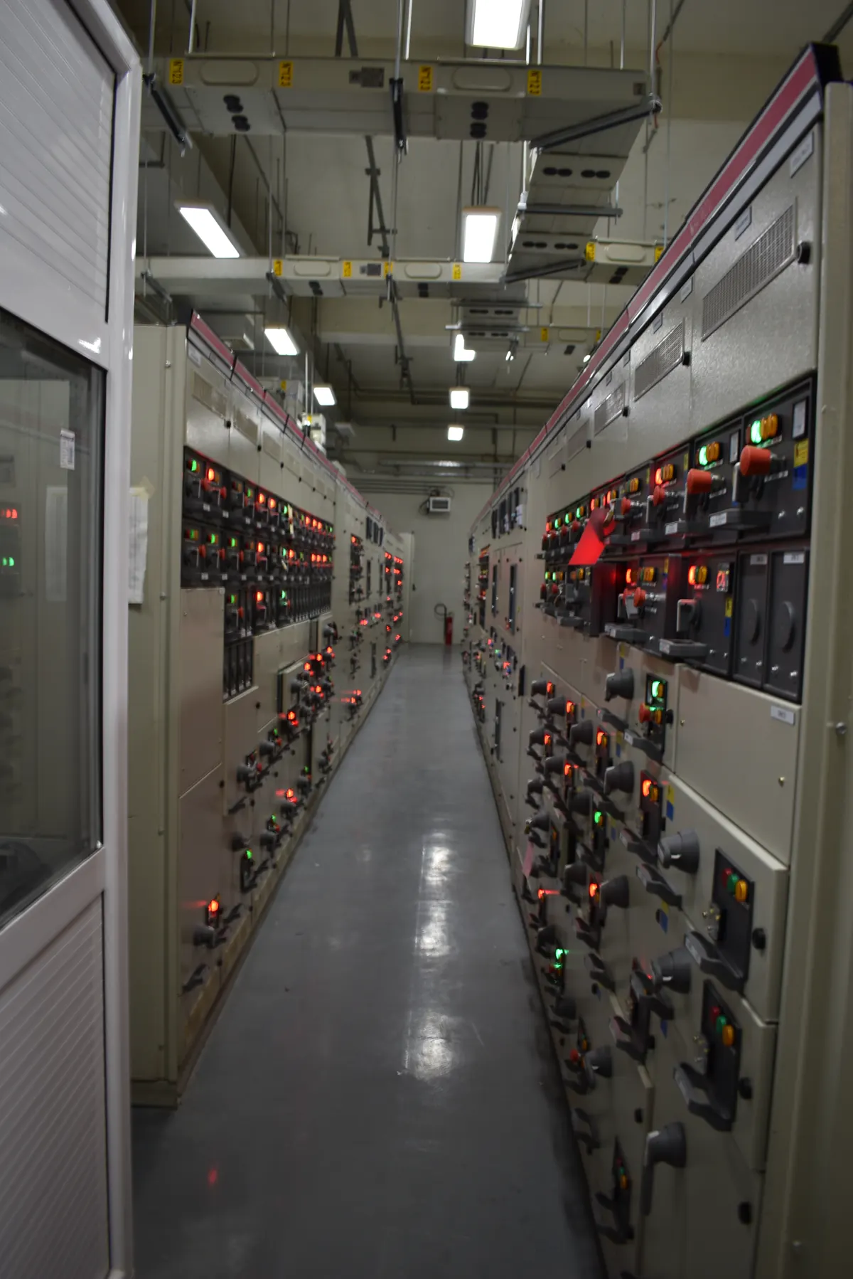 Engineer testing switchgear panels in an MV room