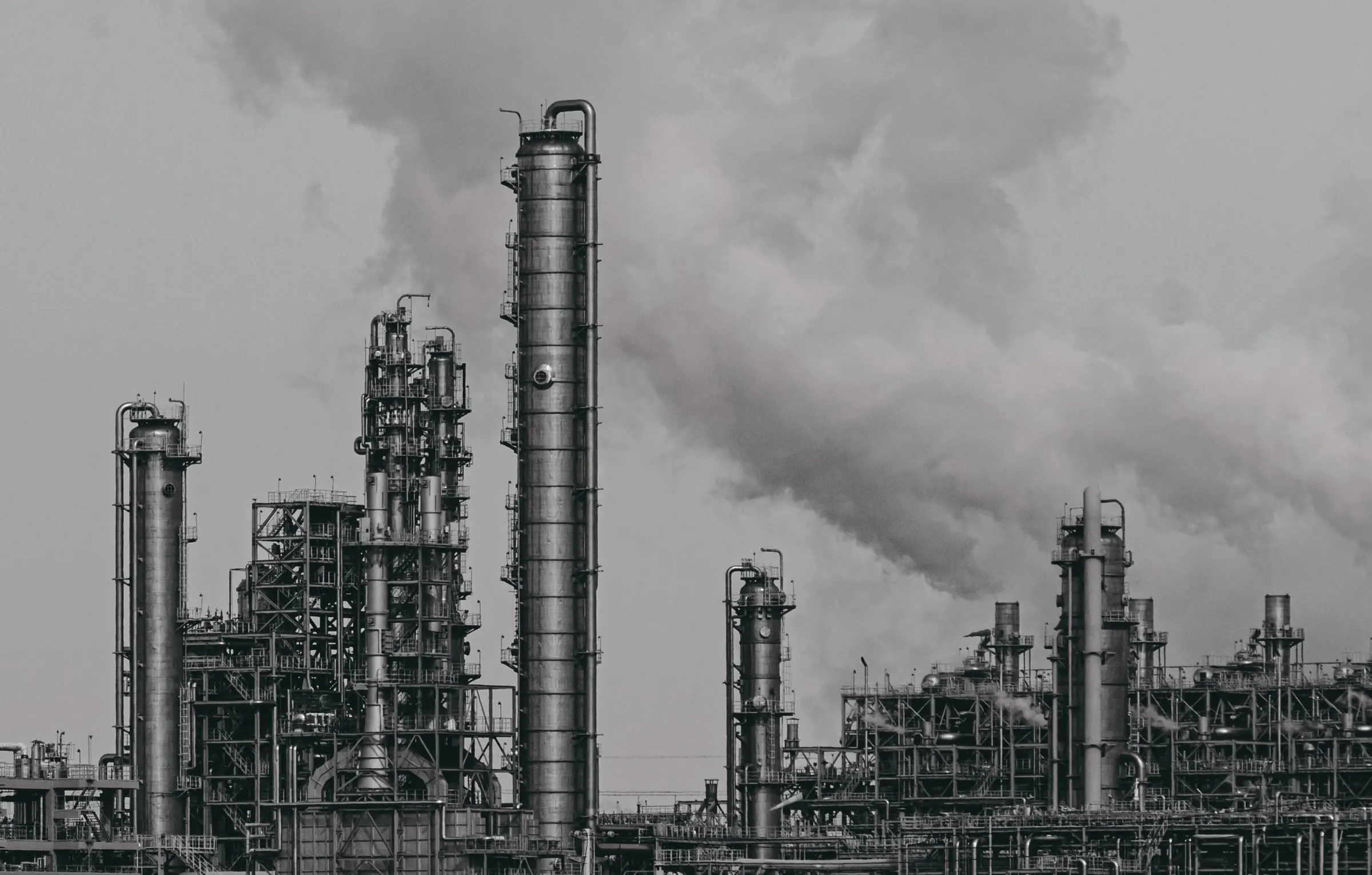 Monochrome view of a petrochemical plant with rising steam