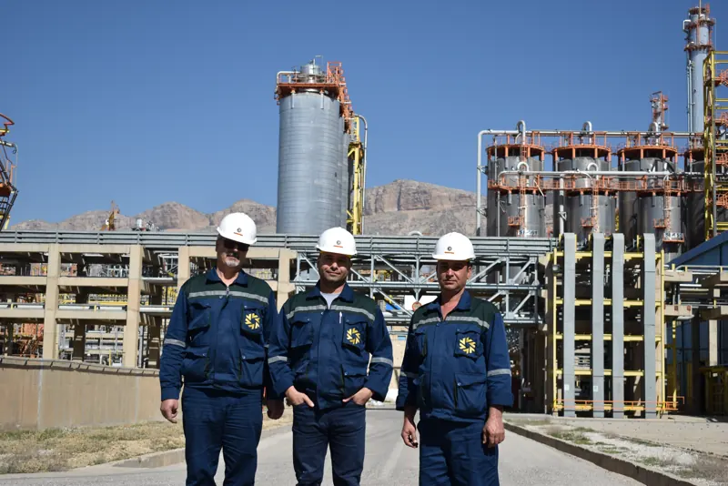 Crew beside the storage tanks